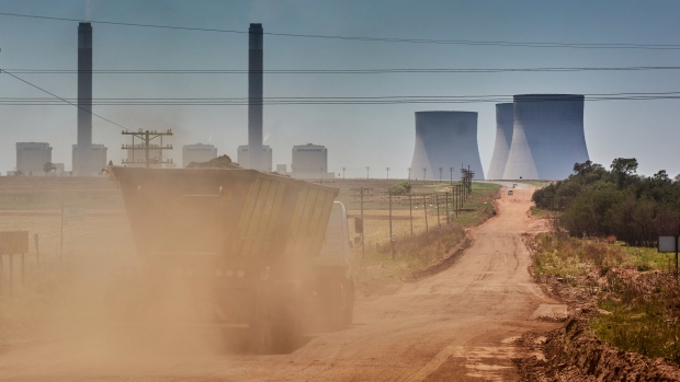 A coal delivery truck drives along a dirt road towards the Eskom Holdings SOC Ltd. Kendal coal-fired power station in Mpumalanga, South Africa, on Friday, Oct. 15, 2021. Envoys from some of the world’s richest nations met with South African cabinet ministers to discuss a climate deal that could channel almost $5 billion toward ending the country’s dependence on coal.