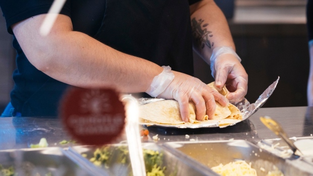 http://www.bnnbloomberg.ca/polopoly_fs/1.1757387!/fileimage/httpImage/image.jpg_gen/derivatives/landscape_620/a-worker-prepares-a-burrito-at-a-chipotle-restaurant-in-naperville-illinois-u-s-on-wednesday-march-2-2022-jack-hartung-chief-financial-officer-of-chipotle-mexican-grill-said-inflation-is-hitting-every-aspect-of-the-restaurant-s-costs-but-he-believes-customers-have-so-far-accepted-the-company-s-decision-to-raise-menu-prices-by-roughly-10-in-2021.jpg