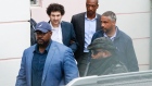 Sam Bankman-Fried, founder of FTX, second left, is escorted out of the Magistrate's Court in Nassau, Bahamas, on Dec. 21. Photographer: Tristan Wheelock/Bloomberg