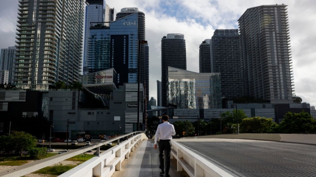 A pedestrian on the South Miami Avenue Bridge in the Brickell neighborhood of Miami, Florida, US, on Thursday, Nov. 16, 2023. Floridians aren’t seeing the let-up in price pressures that other Americans are, as an influx of newcomers is driving up housing costs and fueling a booming economy.