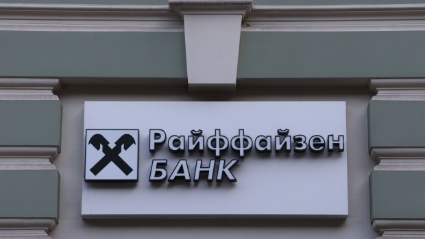 A sign above the entrance to a branch of Raiffeisen Bank JSC in Moscow, Russia, on Monday, Feb. 28, 2022. The Bank of Russia acted quickly to shield the nation’s $1.5 trillion economy from sweeping sanctions that hit key banks, pushed the ruble to a record low and left President Vladimir Putin unable to access much of his war chest of more than $640 billion. Photographer: Andrey Rudakov/Bloomberg
