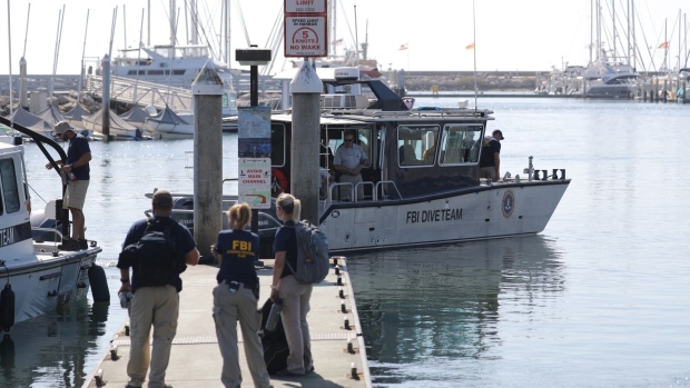 FBI members gather on a jetty as a dive team boat departs in Santa Barbara Harbor in 2019.