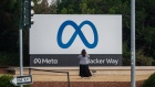 A visitor takes photographs of Meta Platforms signage outside the company's headquarters in Menlo Park, California, U.S., on Friday, Oct. 29, 2021. Photographer: Nick Otto/Bloomberg