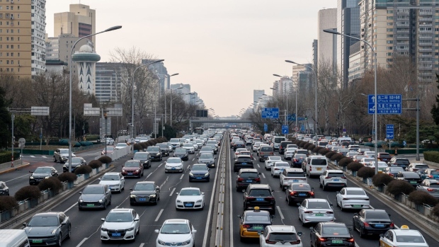 Vehicles travel along a road in Beijing.