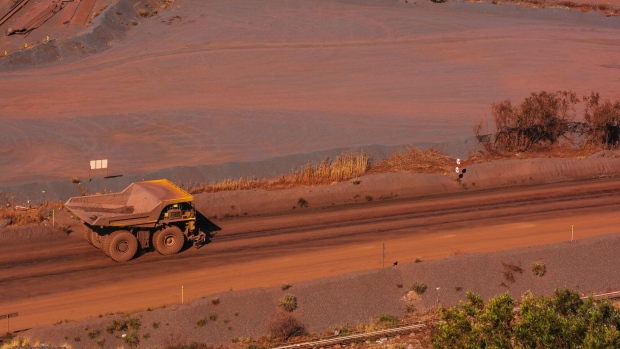 A dumper truck drives into the iron ore excavation pit at the Sishen open cast mine, operated by Kumba Iron Ore Ltd., an iron ore-producing unit of Anglo American Plc, in Sishen, South Africa, on Tuesday, May 22, 2018. Kumba Iron Ore may diversify into other minerals such as manganese and coal as Africa’s top miner of the raw material seeks opportunities for growth and to shield its business from price swings. Photographer: Waldo Swiegers/Bloomberg