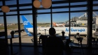 A passenger waits at a departures gate in view of an Air Europa Lineas Aereas SA passenger aircraft at Lisbon Airport, operated by Vinci Airports, in Lisbon, Portugal, on Sunday, Feb. 5, 2023. For Portugal, which has the third-highest debt ratio in the euro area behind Greece and Italy, tourism represents about 15% of the economy. Photographer: Zed Jameson/Bloomberg