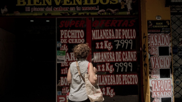 A shopper looks at prices displayed at butcher shop in Buenos Aires, Argentina, on Wednesday, Jan. 10, 2024. Argentina's annual inflation rate is poised to surpass Venezuela in December, making it by far the highest in the region and one of the top in the world.