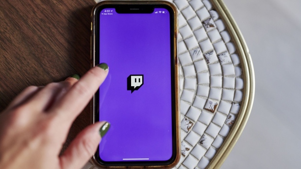 The logo for Twitch is displayed on a smartphone in an arranged photograph taken in Little Falls, New Jersey, U.S., on Thursday, Oct. 8, 2020. Twitch's market share of hours streamed jumped to 91% in the third quarter, up 15% from the second quarter, according to a report from streaming-software provider Streamlabs, which used data from Stream Hatchet. Photographer: Gabby Jones/Bloomberg