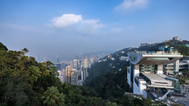 The Peak Tower shopping mall, right, on Victoria Peak in Hong Kong, China, on Tuesday, Jan. 9, 2024. The chill in Hong Kong's housing market is prompting owners of luxury homes to rent out their properties instead of selling. Photographer: Paul Yeung/Bloomberg