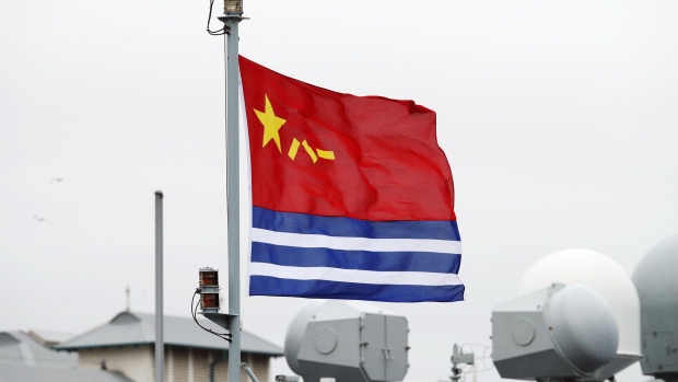 The People's Liberation Army (PLA) Navy flag flies from the Luoma Lake Qiandaohu class replenishment ship as it sits docked in Sydney, Australia. Photographer: Brendon Thorne/Bloomberg