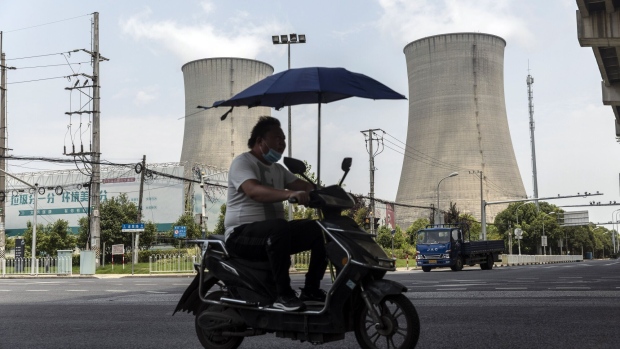 Cooling towers of a thermal power plant in Shanghai, China, on Wednesday, July 27, 2022. The searing heat that has gripped China for over a month has boosted power generation to a record high in southern regions, leading to outages in some places as demand for air-conditioning strains the network. Photographer: Qilai Shen/Bloomberg