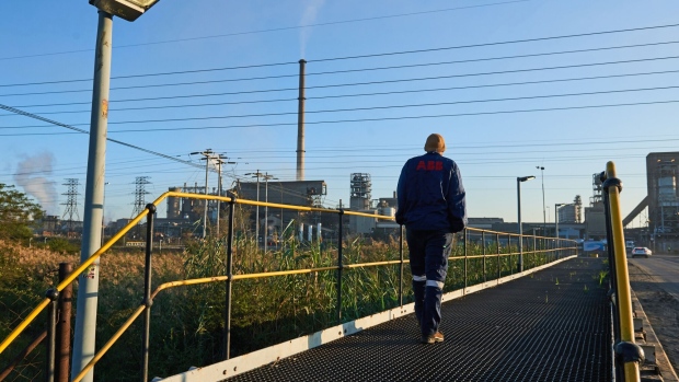 A worker walks towards the Waterval smelter, operated by Anglo American Platinum Ltd., outside Rustenburg, South Africa.