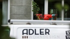 An Adler Group van outside a building housing offices of the Adler Group. Photographer: Krisztian Bocsi/Bloomberg