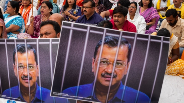 <p>Aam Aadmi Party supporters hold placards with a photograph of Arvind Kejriwal during a protest in New Delhi last month.</p>