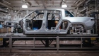 <p>The body of a Rivian R1T electric vehicle pickup truck on the assembly line at the company's manufacturing facility in Normal, Illinois.</p>