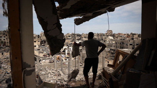 A resident looks at a ravaged neighborhood from a destroyed apartment in Khan Yunis on May 2. Photographer: AFP/Getty Images