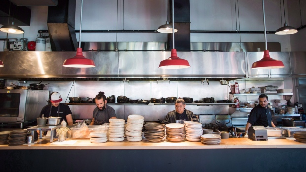 Kitchen staff prepare for dinner service at Edible Canada restaurant in Vancouver, B.C.