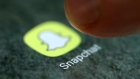 The Snapchat app logo is seen on a smartphone in this illustration