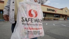 A customer leaves a Safeway store in Cupertino, Calif. Feb. 23, 2011. 