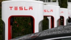 In this May 14, 2015, file photo, Tesla charging stations are shown outside of the Tesla factory