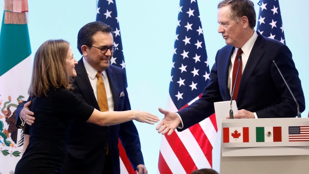 Canadian Foreign Minister Freeland shakes hands with U.S. Trade Representative Lighthizer as Mexican Economy Minister Guajardo looks on during a joint news conference on the closing of the seventh round of NAFTA talks in Mexico City