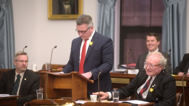Prince Edward Island Premier Wade MacLauchlan pounds his desk alongside Liberal Finance Minister Hea