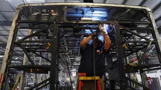 An employee welds the frame of an electric vehicle at the BYD Coach and Bus factory in Lancaster, California, U.S., on Thursday, Oct. 5, 2017. BYD unveiled the newly expanded 450,000 square foot factory on Friday, North America's largest electric bus manufacturing facility.