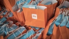 Gift bags sit stacked during the unveiling event for the Xiaomi Corp. Mi MIX 2S smartphone in Shanghai, China, on Tuesday, March 27, 2018. Xiaomi unveiled its latest top-tier smartphone to bring the fight to Apple and Samsung, as the Chinese startup readies a highly anticipated initial public offering.