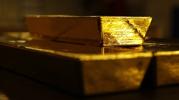 Bars of gold bullion sit underneath a 12.5 kilogram gold bar at the Valcambi SA precious metal refinery in Balerna, Switzerland, on Tuesday, April 24, 2018. Gold's haven qualities have come back in focus this year as President Donald Trump’s administration picks a series of trade fights with friends and foes, and investors fret about equity market wobbles that started on Wall Street and echoed around the world.