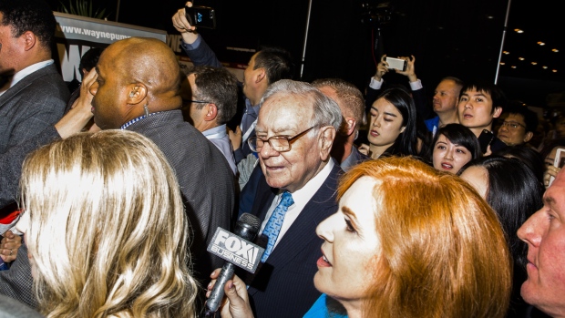 Warren Buffett, chairman and chief executive officer of Berkshire Hathaway Inc., tours the shopping floor ahead of the Berkshire Hathaway annual meeting in Omaha, Nebraska, U.S., on Saturday, May 5, 2018. The rules, which require Berkshire to report unrealized gains or losses in equity investments in net income, helped fuel a $1.14 billion loss at Warren Buffett's Berkshire Hathaway Inc. in the first quarter.