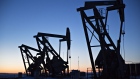 The silhouettes of pumpjacks are seen above oil wells in the Bakken Formation in North Dakota, U.S.