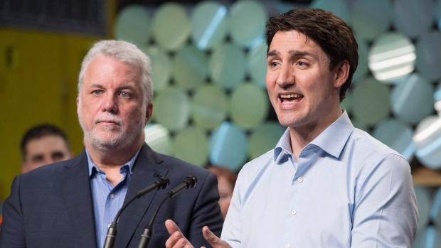 Quebec Premier Philippe Couillard, left, looks on as Prime Minister Justin Trudeau