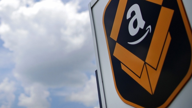 The Amazon.com logo is displayed outside the company\'s fulfillment center in Kenosha, Wisconsin, U.S., on Tuesday, Aug. 1, 2017. Amazon.com Inc. held a giant job fair at nearly a dozen U.S. warehouses as part of its effort to hire 100,000 people in the U.S. by 2018.