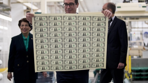 Treasury secretary Steven Mnuchin views an uncut sheet of $1 dollar notes bearing his name at the U.S. Bureau of Engraving and Printing in Washington, D.C. last year.