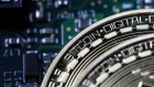 Two coins representing Bitcoin cryptocurrency sit on a computer circuit board in this arranged photograph in London, U.K., on Tuesday, Feb. 6, 2018. Cryptocurrencies tracked by Coinmarketcap.com have lost more than $500 billion of market value since early January as governments clamped down, credit-card issuers halted purchases and investors grew increasingly concerned that last year’s meteoric rise in digital assets was unjustified.