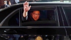 Kim Jong Un, North Korea's leader, waves from a limousine as he departs the inter-Korean summit at the village of Panmunjom in the Demilitarized Zone (DMZ) in Paju, South Korea, on Friday, April 27, 2018.