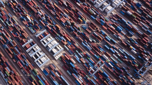 Shipping containers stand at the Qingdao Qianwan Container Terminal in this aerial photograph taken in Qingdao, China, on Monday, May 7, 2018. China's overseas shipments exceeded estimates while imports surged, as the global economy continued to support demand. 