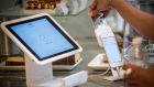 A customer removes a credit card into Square Inc. device while making a payment in San Francisco.