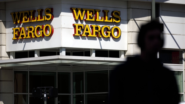 A pedestrian passes in front of a Wells Fargo & Co. bank branch in New York, U.S., on Tuesday, Jan. 9, 2018. Wells Fargo & Co. is scheduled to release earnings figures on January 12. 