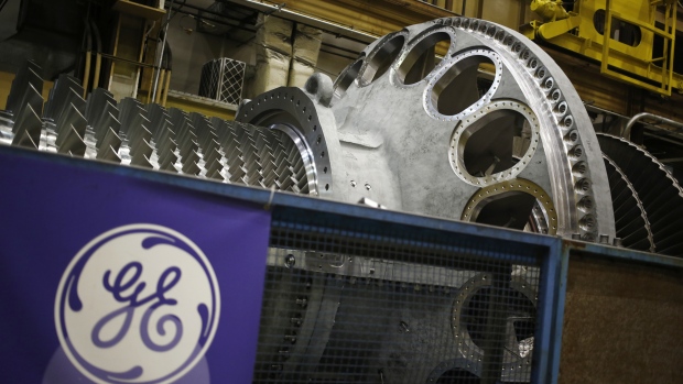 A logo is displayed next to a gas turbine at the General Electric Co. (GE) energy plant in Greenville, South Carolina, U.S., on Tuesday, Jan. 10, 2017. General Electric Co. is scheduled to release earnings figures on January 20. 