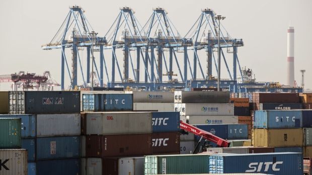 Shipping containers and cranes stand at the Qingdao Qianwan Container Terminal in Qingdao, China, on Monday, May 7, 2018. China's overseas shipments exceeded estimates while imports surged, as the global economy continued to support demand. 