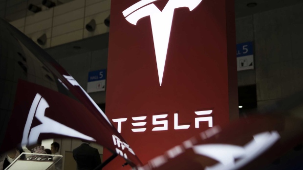 Tesla Motors Inc. logo is displayed at the Tesla Motors Inc. booth at the Cutting-Edge IT & Electronics Comprehensive Exhibition (CEATEC) at Makuhari Messe in Chiba, Japan, on Tuesday, Oct. 4, 2016. The show runs through Oct. 7. Photographer: Tomohiro Ohsumi/Bloomberg