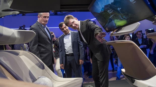 Brian Krzanich, chief executive officer of Intel, from left, Amnon Shashua, chairman and chief technology officer of Mobileye, and Klaus Froehlich, member of the management board at BMW, view the BMWi Inside Future concept vehicle during the Consumer Electronics Show in Las Vegas on Jan. 4, 2017. Photographer: David Paul Morris/Bloomberg