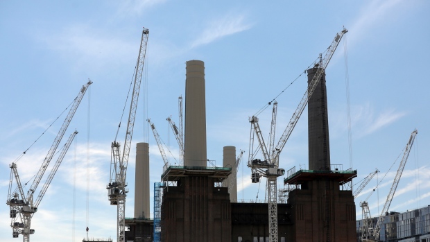 Cranes stand above the Battersea Power Station office, retail and residential development, in London. Photographer: Chris Ratcliffe/Bloomberg