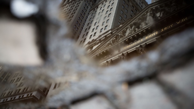 The New York Stock Exchange (NYSE) is reflected in a puddle in New York, U.S. 