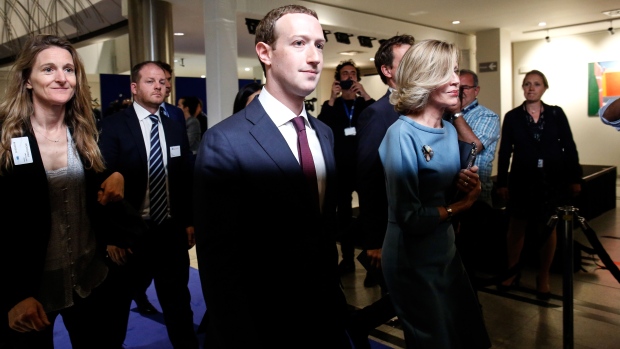 Mark Zuckerberg, chief executive officer and founder of Facebook Inc., center, leaves after testifying at the European Union (EU) parliament in Brussels, Belgium, on Tuesday, May 22, 2018. Zuckerberg offered European Union lawmakers his latest mea culpa for the social network's role in a privacy scandal that tarnished his company's reputation. Photographer: Dario Pignatelli/Bloomberg