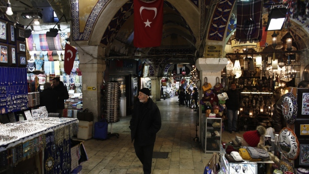 A pedestrian walks past retail stores in the Grand Bazaar in Istanbul. Photographer: Kostas Tsironis/Bloomberg