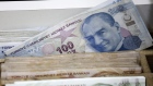 An image of Mustafa Kemal Attaturk, Turkey's founder, sits on a 100 Turkish lira banknote in a currency exchange in Istanbul, Turkey, on Friday, May 18, 2018. The lira has weakened almost 10 percent percent since, compounded by President Recep Tayyip Erdogan’s plans to take more responsibility for monetary policy after elections next month. 
