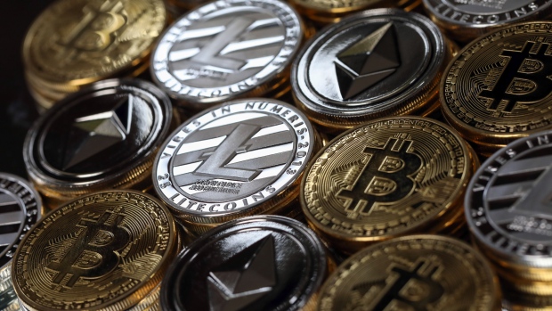 A collection of bitcoin, litecoin and ethereum tokens sit in this arranged photograph in Danbury, U.K., on Tuesday, Oct. 17, 2017. On Wednesday, billionaire Warren Buffett said on CNBC that most digital coins won't hold their value. 