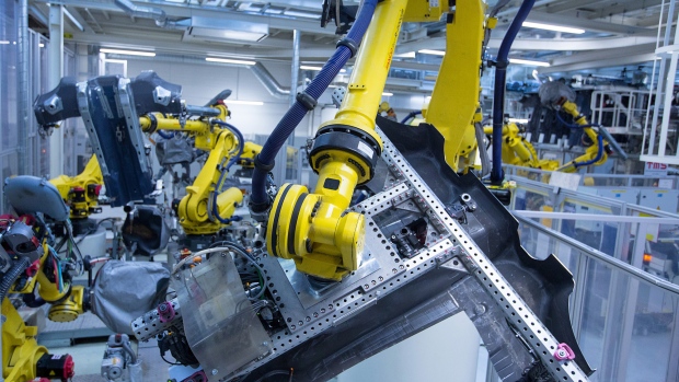 Robotic arms weld parts to be used in an automobile chassis in the Volkswagen AG factory, as part of the Think Blue sustainability initiative in Wolfsburg, Germany, on Friday, May 19, 2017. European car sales fell the most in four years in April as the shift of Easter from March reduced buyers time for shopping, while registrations in the U.K. were further sapped by tax changes. 